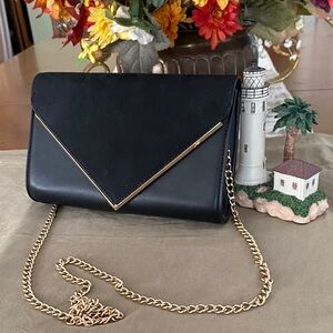 Black clutch convertible to shoulder bag